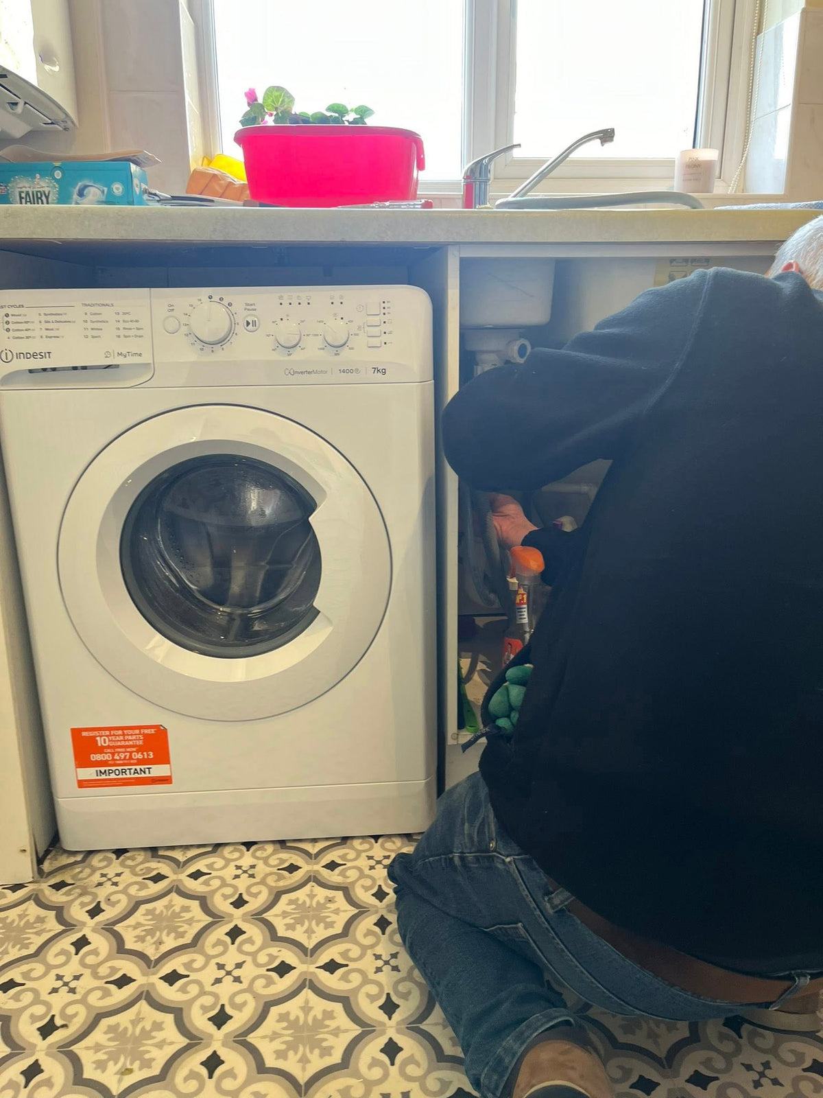 A Bright Ideas fitter installing a washing machine